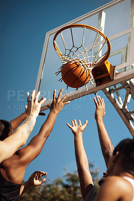 Buy stock photo Closeup shot of a group of sporty young men playing basketball on a sports court