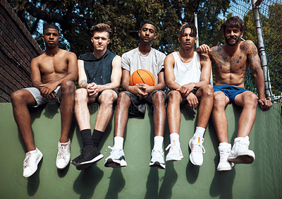 Buy stock photo Portrait of a group of sporty young men hanging out on a basketball court