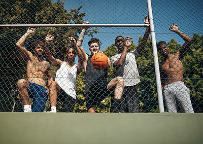 Buy stock photo Portrait of a group of sporty young men leaning against a fence on a sports court