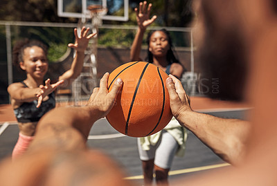 Buy stock photo Shot of a group of sporty young people playing basketball on a sports court