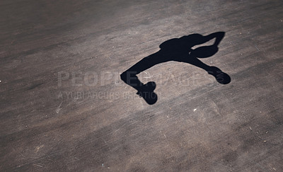 Buy stock photo Shot of the shadow of a man throwing a basketball on a sports court
