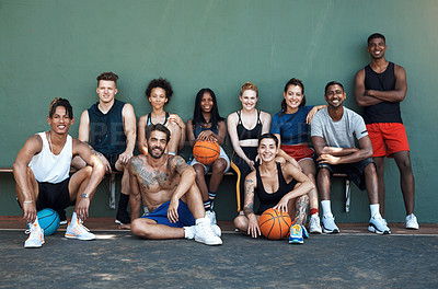 Buy stock photo Portrait of a group of sporty young people taking a break after a game of basketball