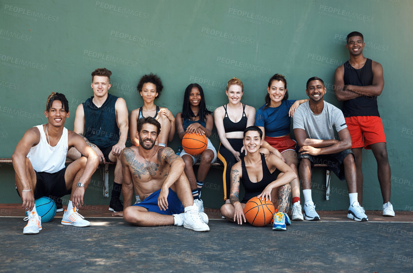 Buy stock photo Portrait of a group of sporty young people taking a break after a game of basketball