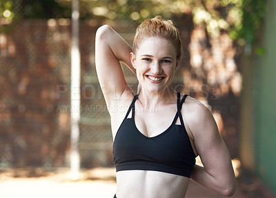 Buy stock photo Cropped portrait of an attractive young female athlete stretching while standing on the basketball court