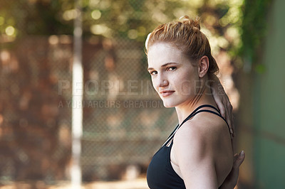 Buy stock photo Cropped portrait of an attractive young female athlete stretching while standing on the basketball court
