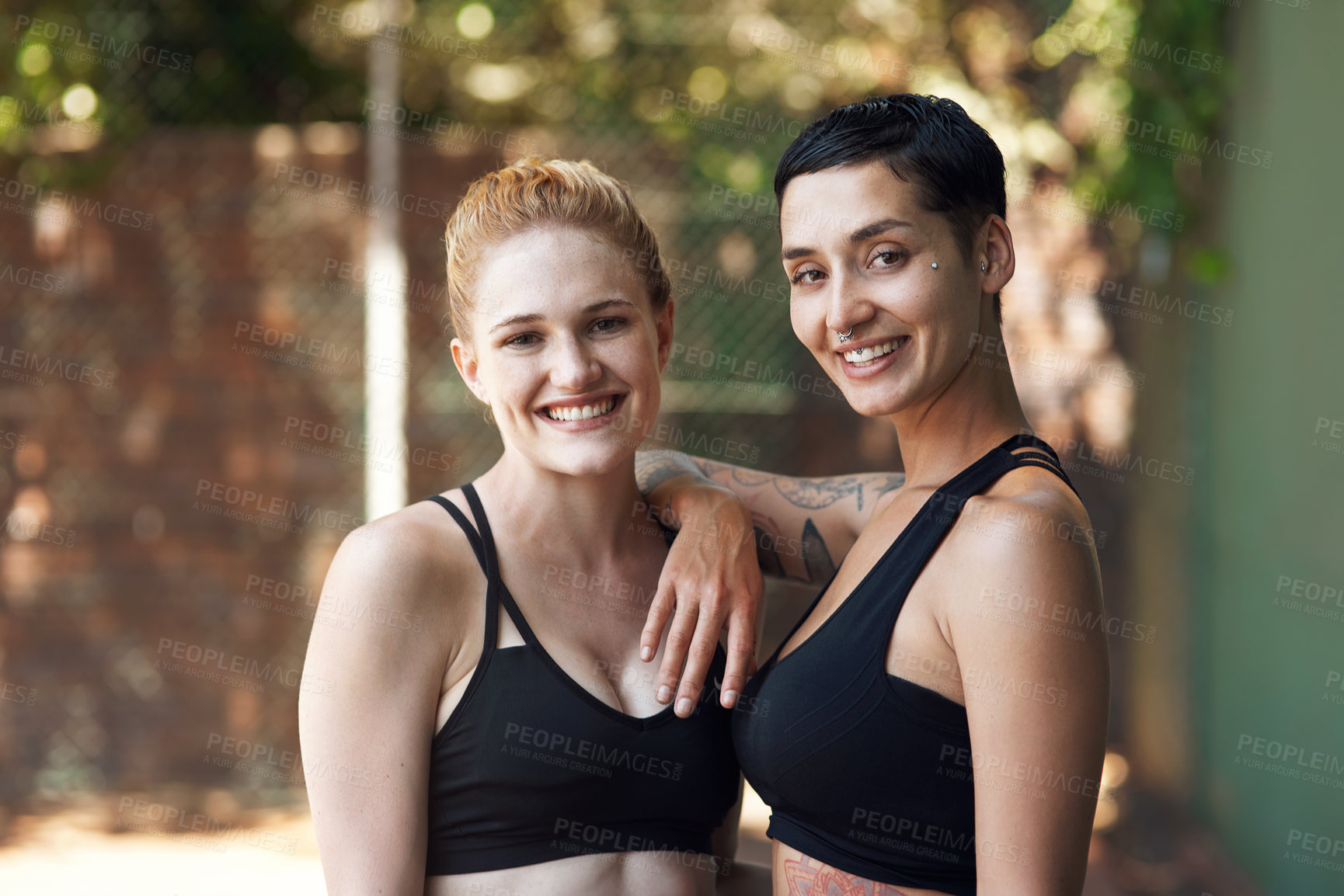 Buy stock photo Cropped portrait of two attractive young female athletes standing together on the basketball court