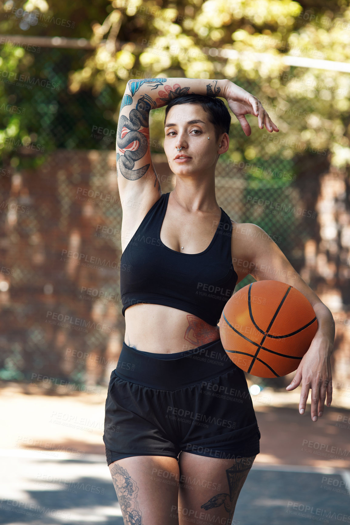 Buy stock photo Cropped portrait of an attractive young female athlete standing on the basketball court