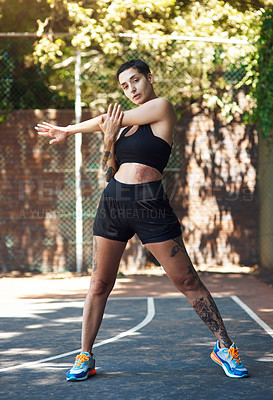 Buy stock photo Full length portrait of an attractive young female athlete stretching while standing on the basketball court