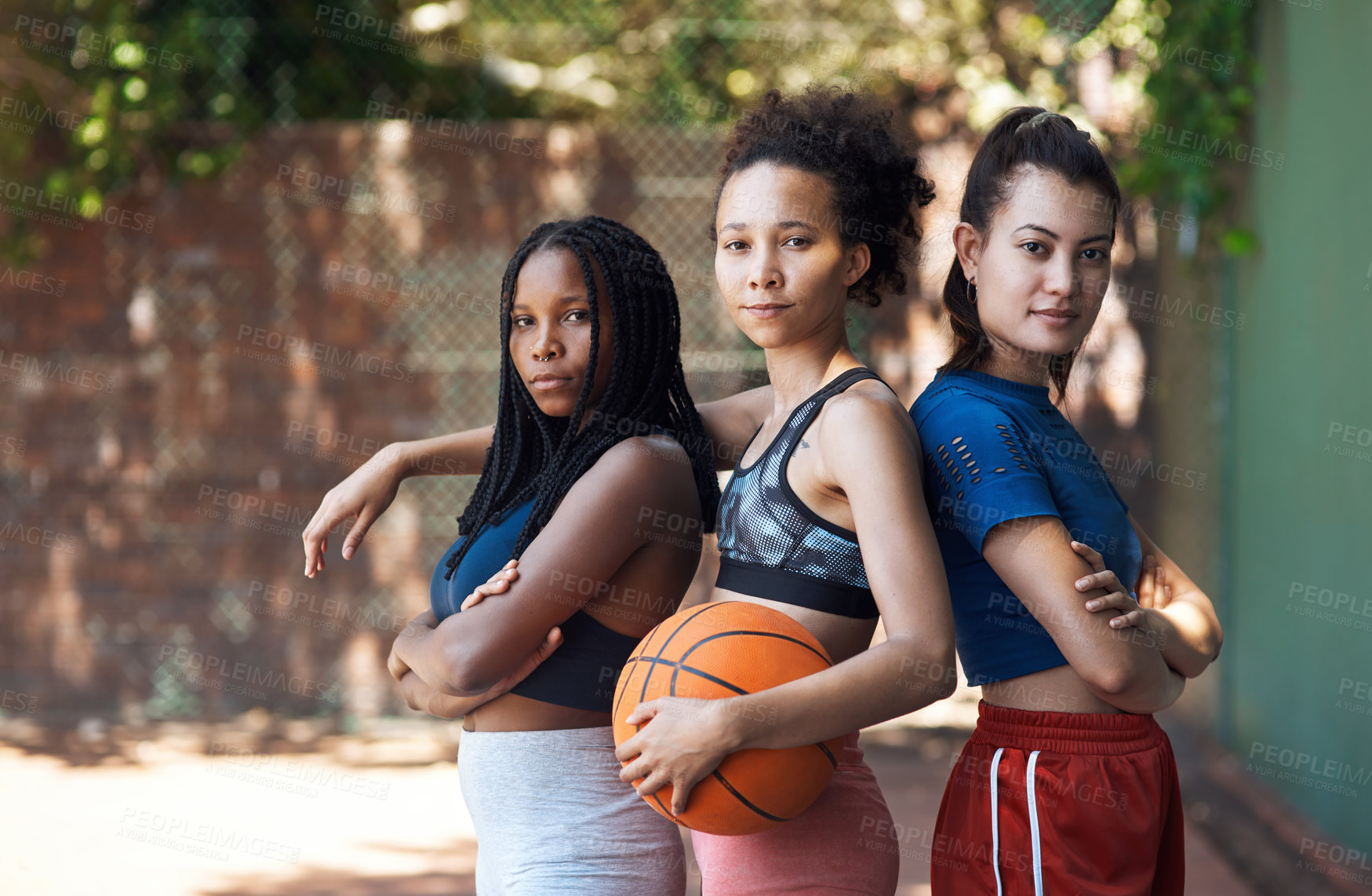Buy stock photo Cropped portrait of three attractive young female athletes standing together on the basketball court