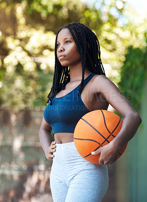 Buy stock photo Cropped shot of an attractive young female athlete standing on the basketball court