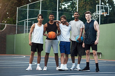 Buy stock photo Portrait of a group of sporty young men hanging out on a basketball court