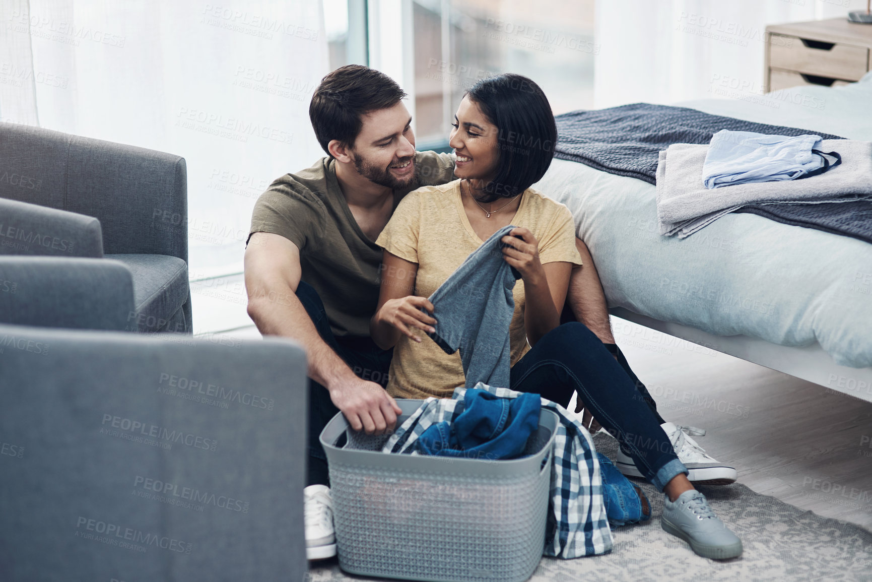 Buy stock photo Laundry, fold and happy couple with clothes in basket for cleaning, chore routine and hygiene in home. Marriage, relationship and man and woman with washing for housekeeping, helping and housework