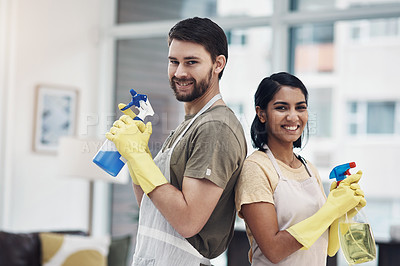 Buy stock photo Shot of a happy young couple getting ready to disinfectant their home