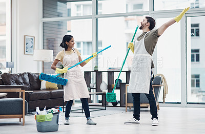 Buy stock photo Shot of a happy young couple having fun while mopping the floor at home