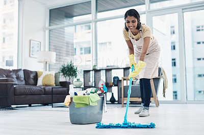 Buy stock photo Shot of a young woman mopping the floor at home