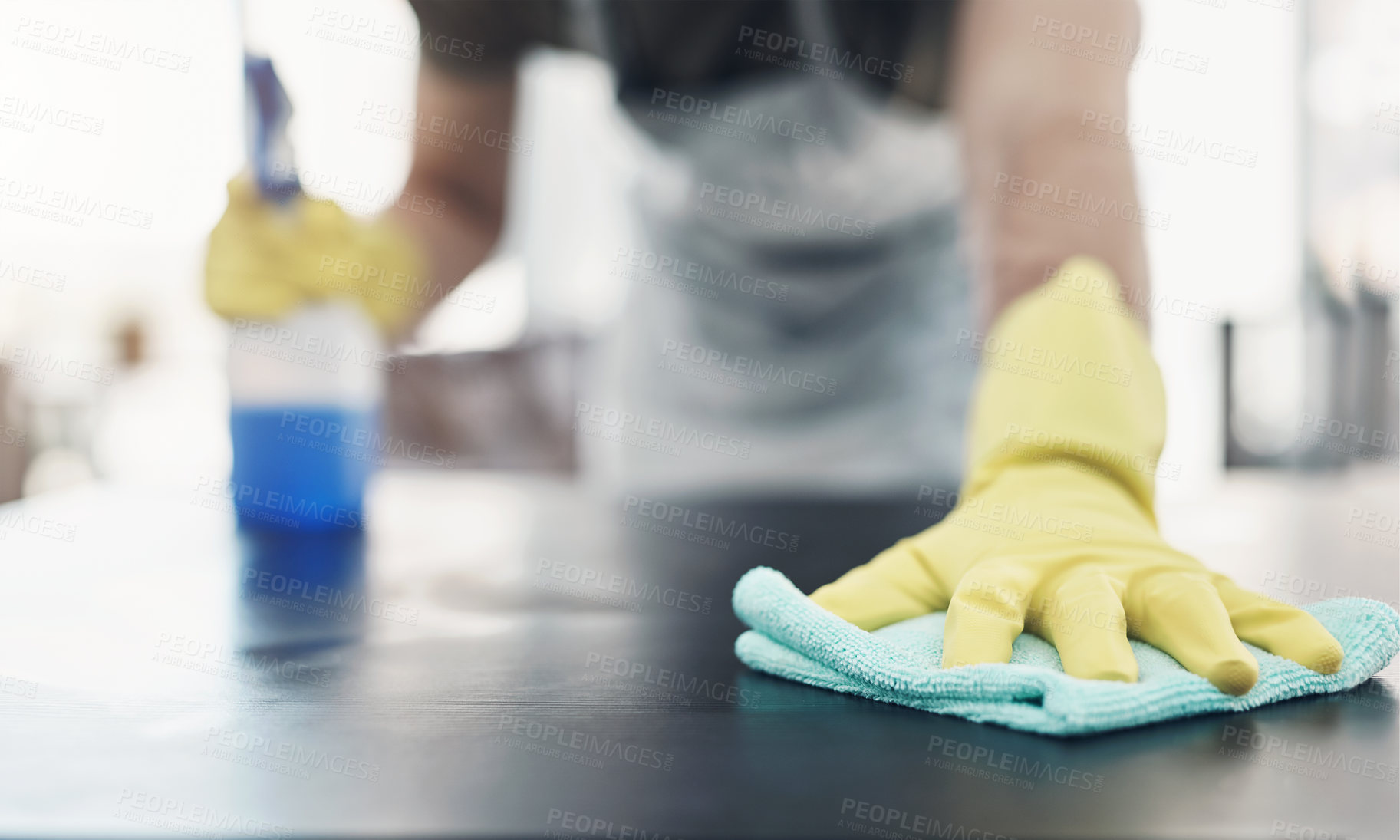 Buy stock photo Home, table and hands with spray for cleaning, hygiene, disinfection for housework by closeup. Apartment, person and gloves for safety, surface bacteria and chores with liquid detergent for fabric