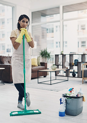 Buy stock photo Shot of a young woman cleaning her home