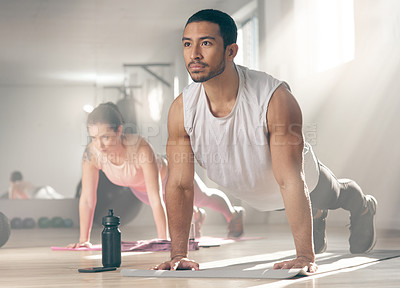 Buy stock photo Shot of two young athletes working out together at the gym