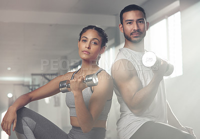 Buy stock photo Cropped shot of two young athletes holding dumbbells