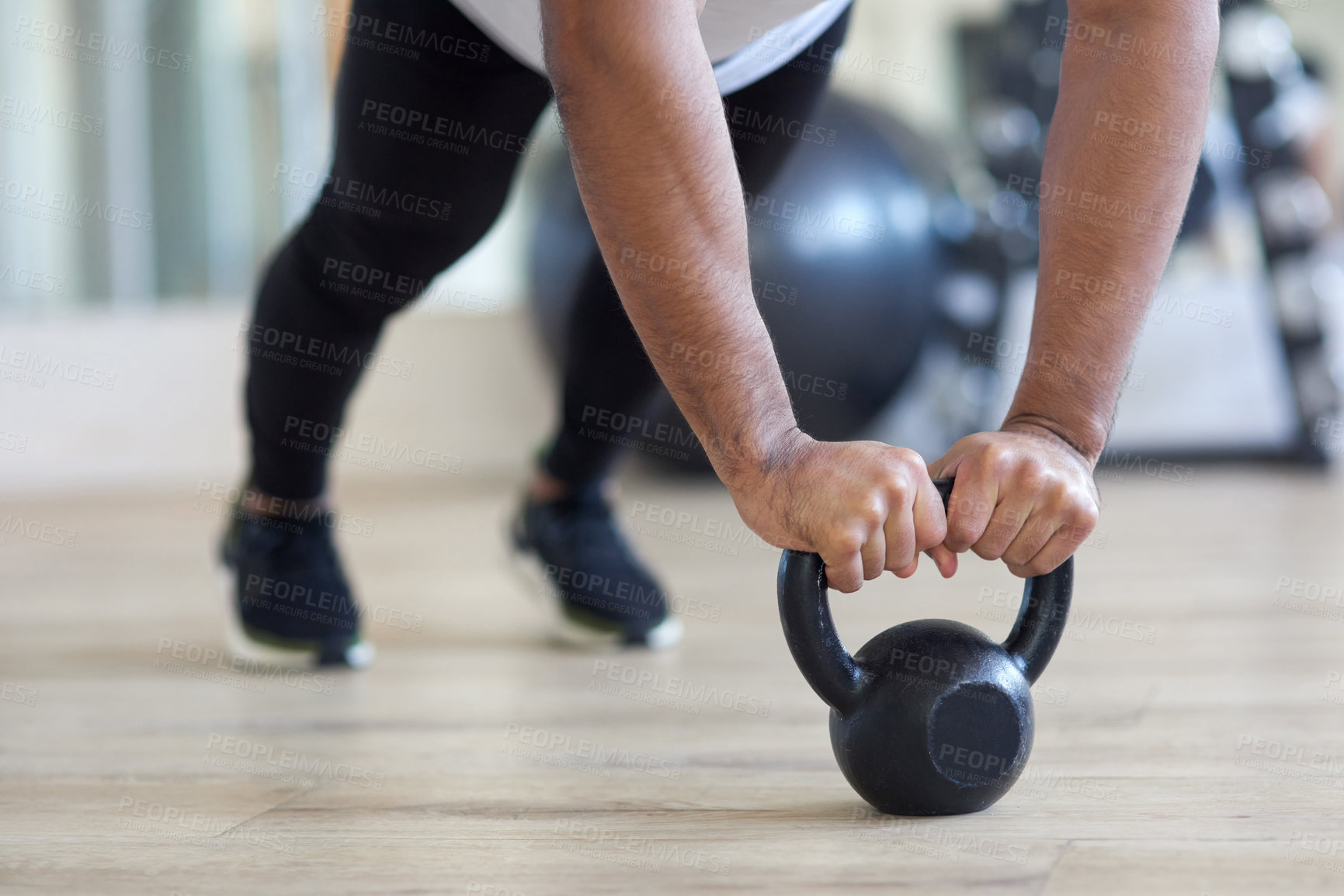 Buy stock photo Shot of a male athlete working out with a kettle bell