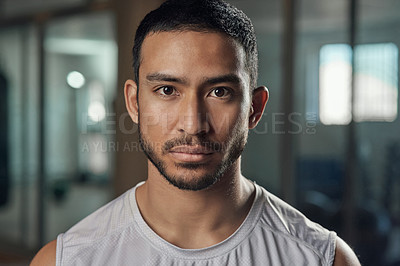 Buy stock photo Cropped portrait of a handsome young male athlete standing in the gym