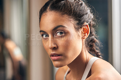 Buy stock photo Cropped portrait of an attractive young female athlete in the gym