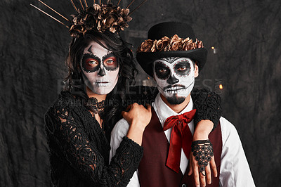 Buy stock photo Cropped portrait of an affectionate young couple dressed in their Mexican-style halloween costumes