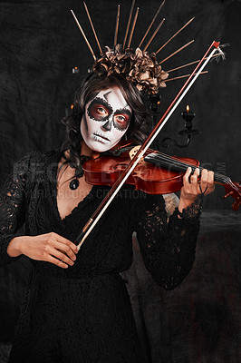 Buy stock photo Cropped portrait of an attractive young woman dressed in her Mexican-style halloween costume playing a violin