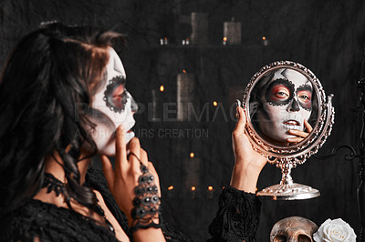 Buy stock photo Cropped shot of an attractive young woman dressed in her Mexican-style halloween costume looking in a mirror