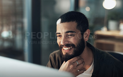 Buy stock photo Shot of a young businessman using a computer during a late night in a modern office