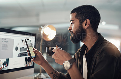 Buy stock photo Shot of a young businessman having coffee and using a smartphone during a late night in a modern office