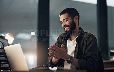 Buy stock photo Shot of a young businessman using a laptop during a late night at work