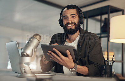 Buy stock photo Shot of a young man using a headset, microphone and digital tablet during a late night at work