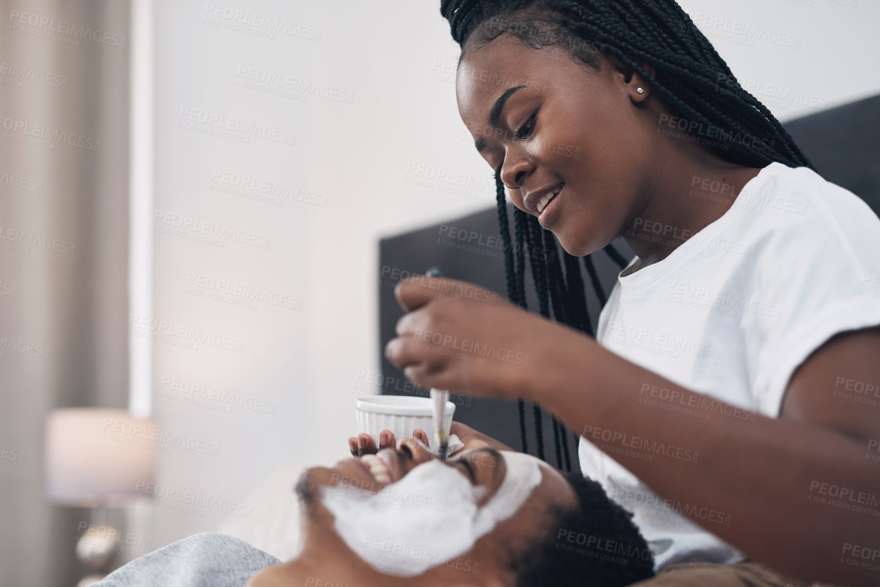 Buy stock photo Shot of a young couple getting homemade facials together at home