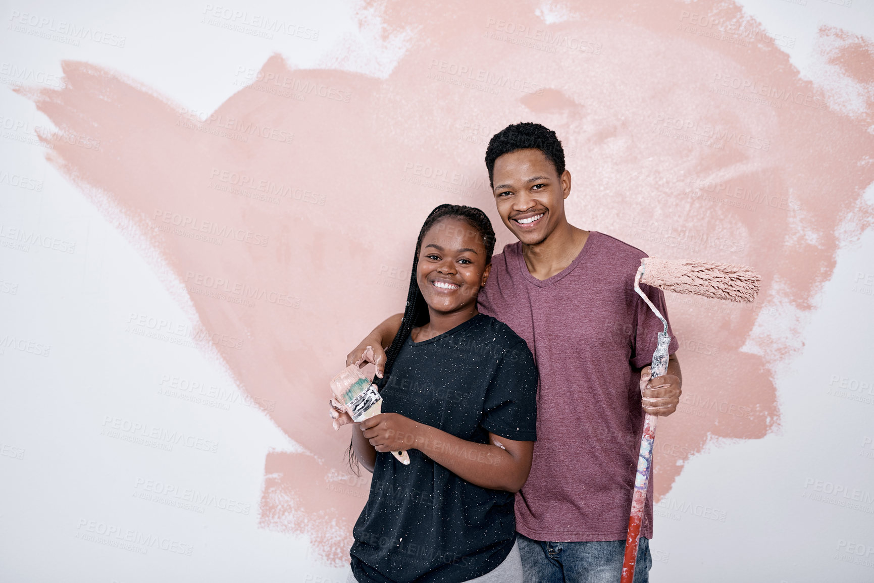 Buy stock photo Shot of a young couple painting a wall pink