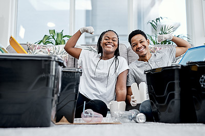 Buy stock photo Shot of a young couple recycling their trash at home
