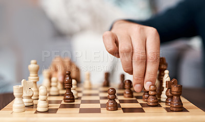 Buy stock photo Shot of an unrecognisable man playing a game of backgammon at home
