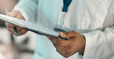 Buy stock photo Closeup shot of an unrecognisable scientist holding a clipboard in a lab