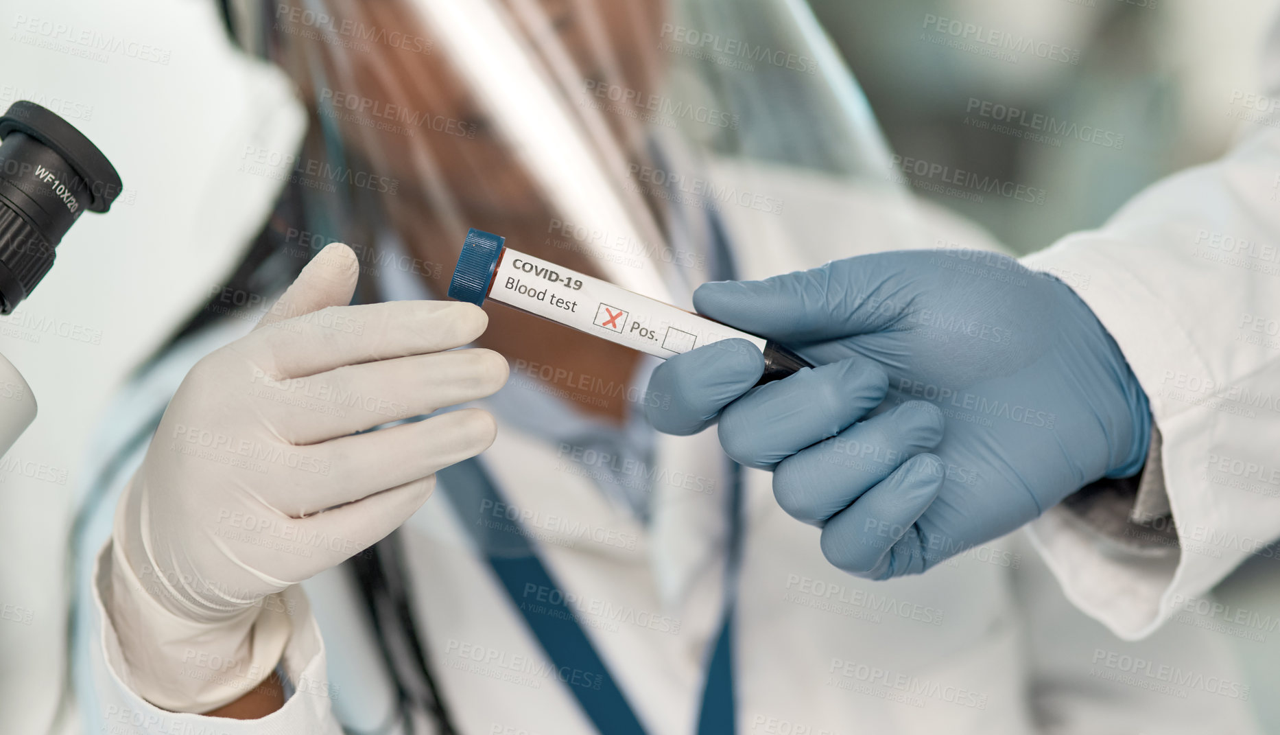 Buy stock photo Closeup shot of an unrecognisable scientist holding a blood filled test tube labelled with a positive Covid-19 test result