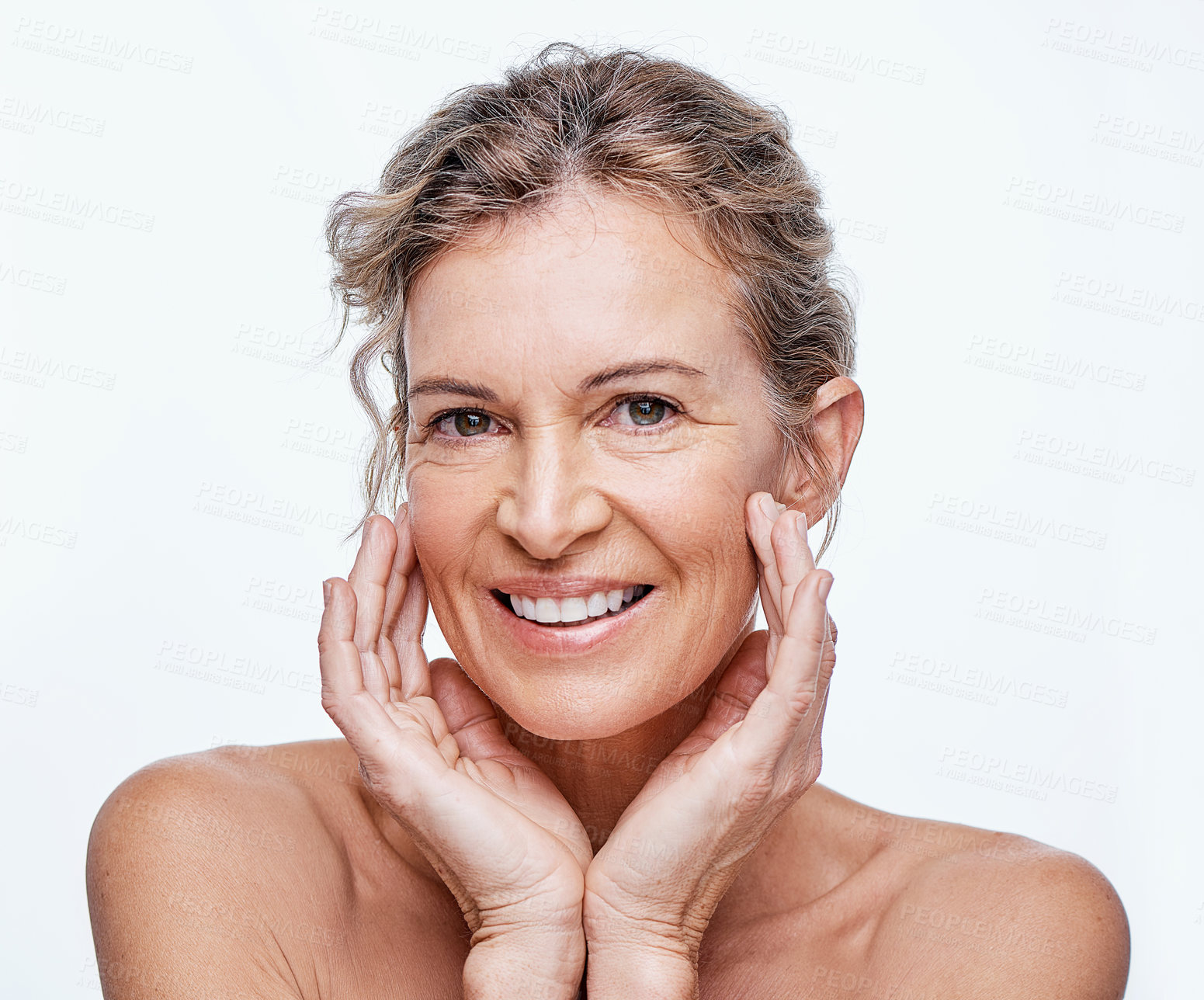 Buy stock photo Shot of a beautiful mature woman posing against a white background