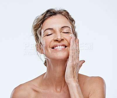 Buy stock photo Skincare, smile and a woman with an anti aging cream isolated on a white background in a studio. Happy, moisturize and a mature model with facial lotion for beauty, wellness and care of skin