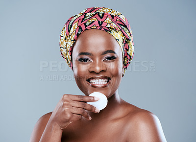 Buy stock photo Studio portrait of a beautiful young woman posing with a jar of face lotion against a grey background
