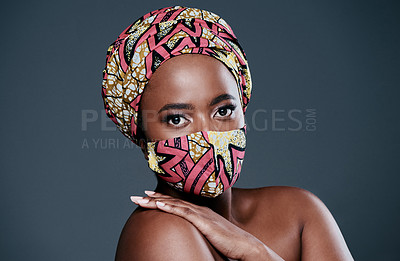 Buy stock photo Studio portrait of a beautiful young woman wearing a mask against a grey background