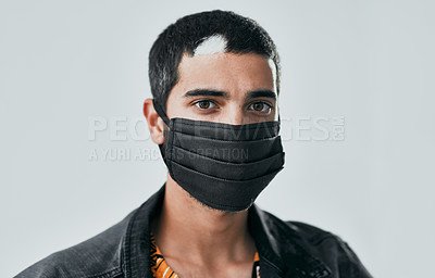 Buy stock photo Studio shot of a masked young man posing against a grey background