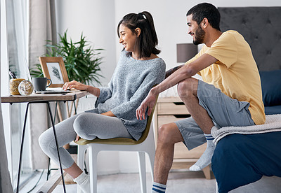 Buy stock photo Shot of a happy young couple working from home