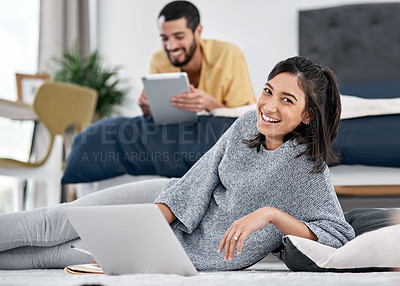 Buy stock photo Shot of a young couple using their wireless devices in bed.