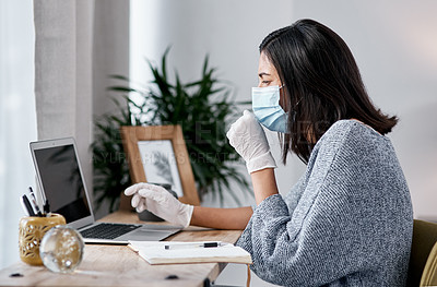 Buy stock photo Shot of a masked young woman coughing while working from home