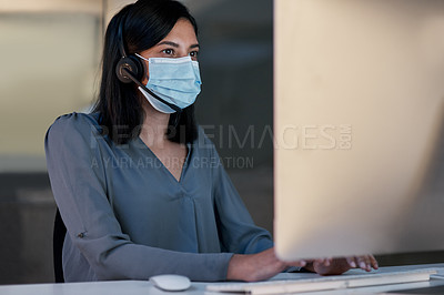 Buy stock photo Call center, woman and face mask at computer for customer service, telemarketing sales and CRM consulting in office. Female agent, desktop and covid safety for online telecom advice, support and help