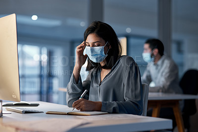 Buy stock photo Call center, woman and notebook at computer with mask for customer support, sales and CRM consulting at night. Female agent, telemarketing and virus protection on face in office for administration 