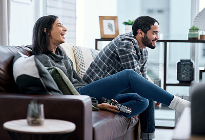 Buy stock photo Shot of a young couple watching tv together at home